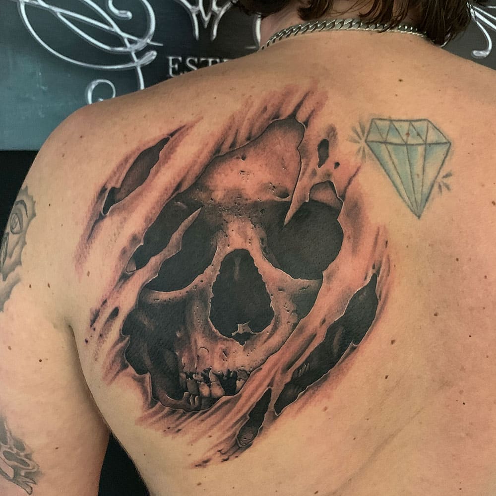 Ripped skin skull tattoo