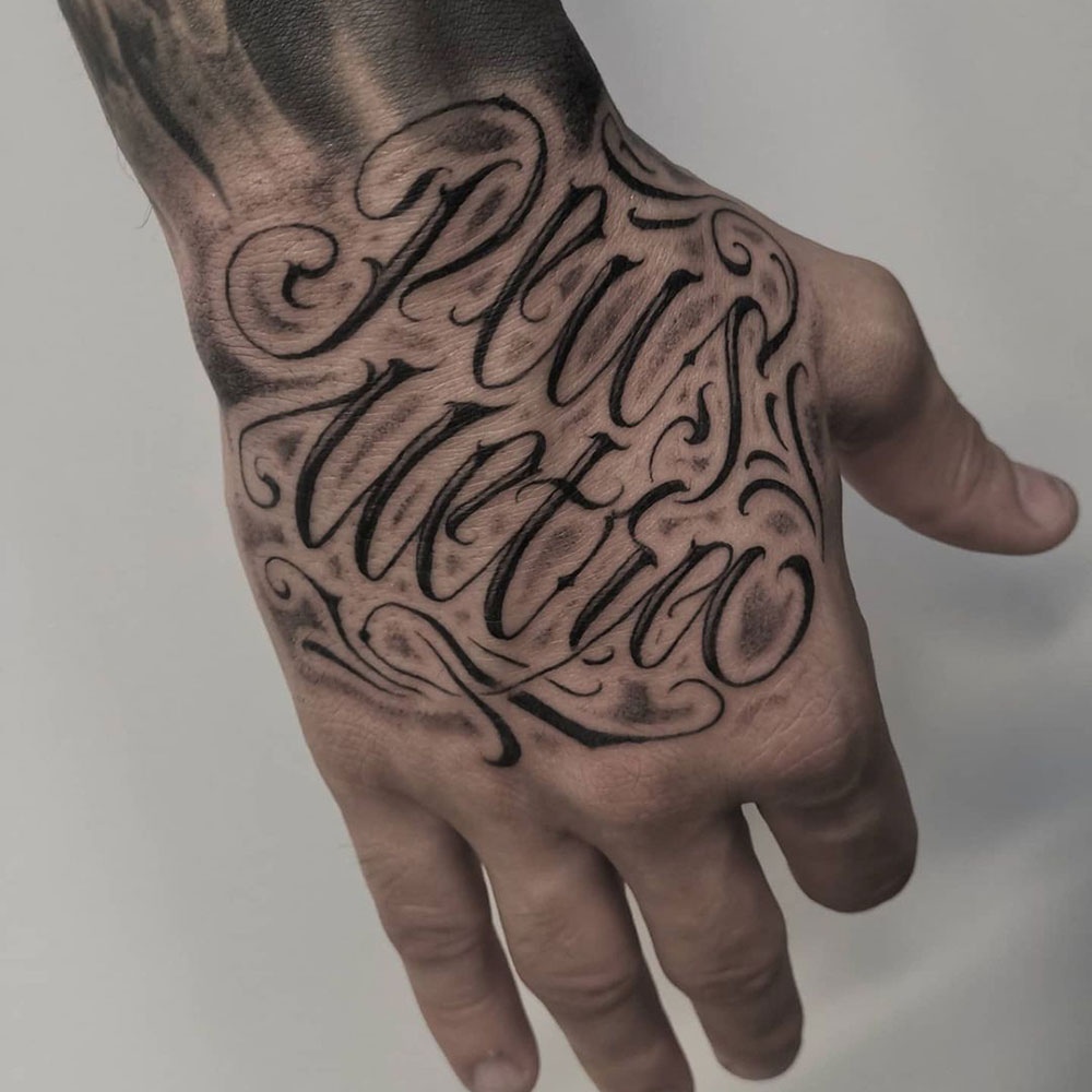 Freehand lettering hand tattoo Lorenzo