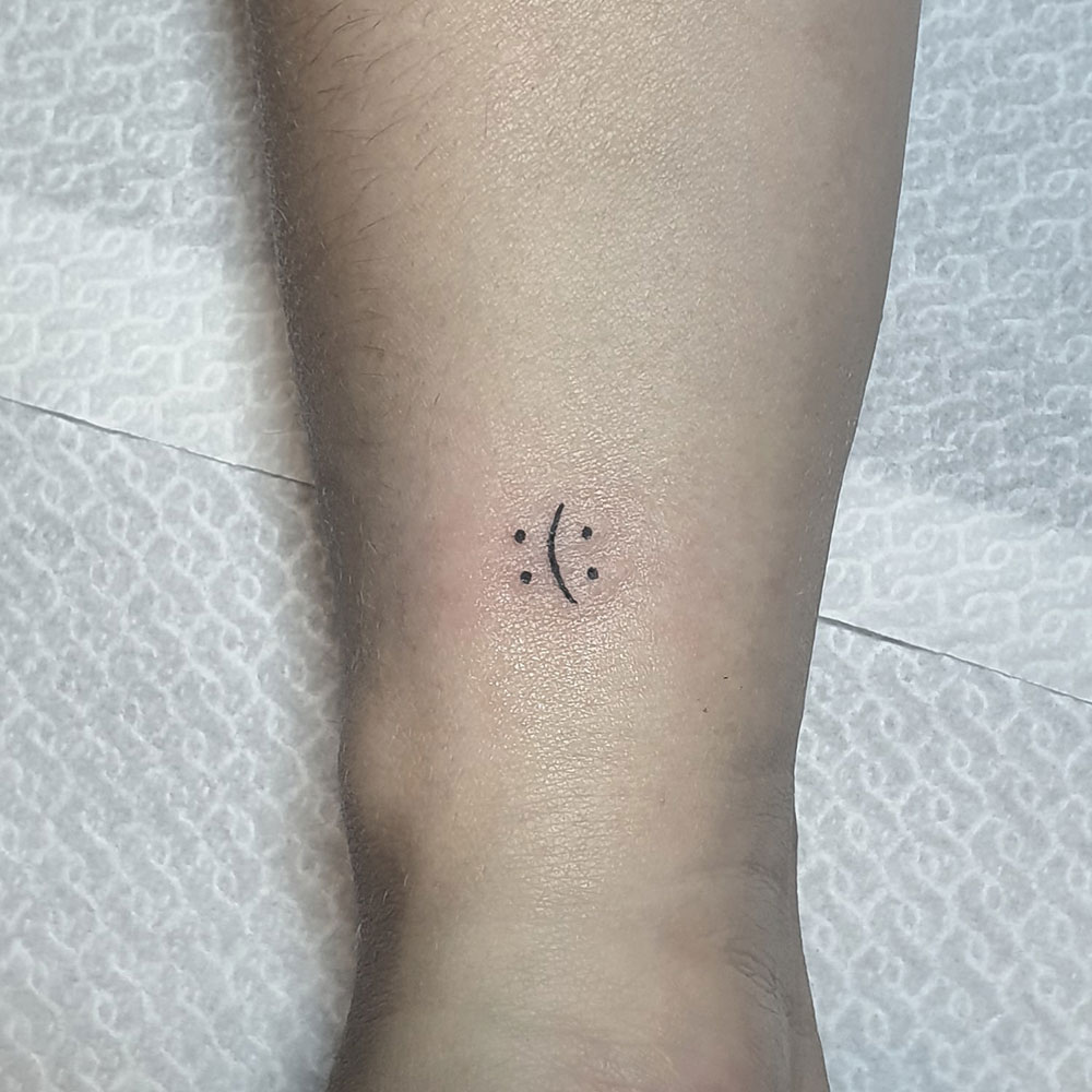 Double sided smiley tattoo Sem